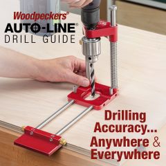 Using the Auto-Line Drill Guide to drill a hole mid-field on a large plywood workpiece while referencing the edge with the fence.