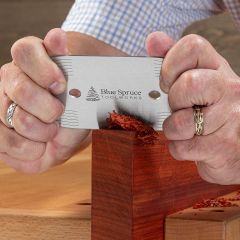 Blue Spruce Card Scraper flattening an edge of a Padauk billet.